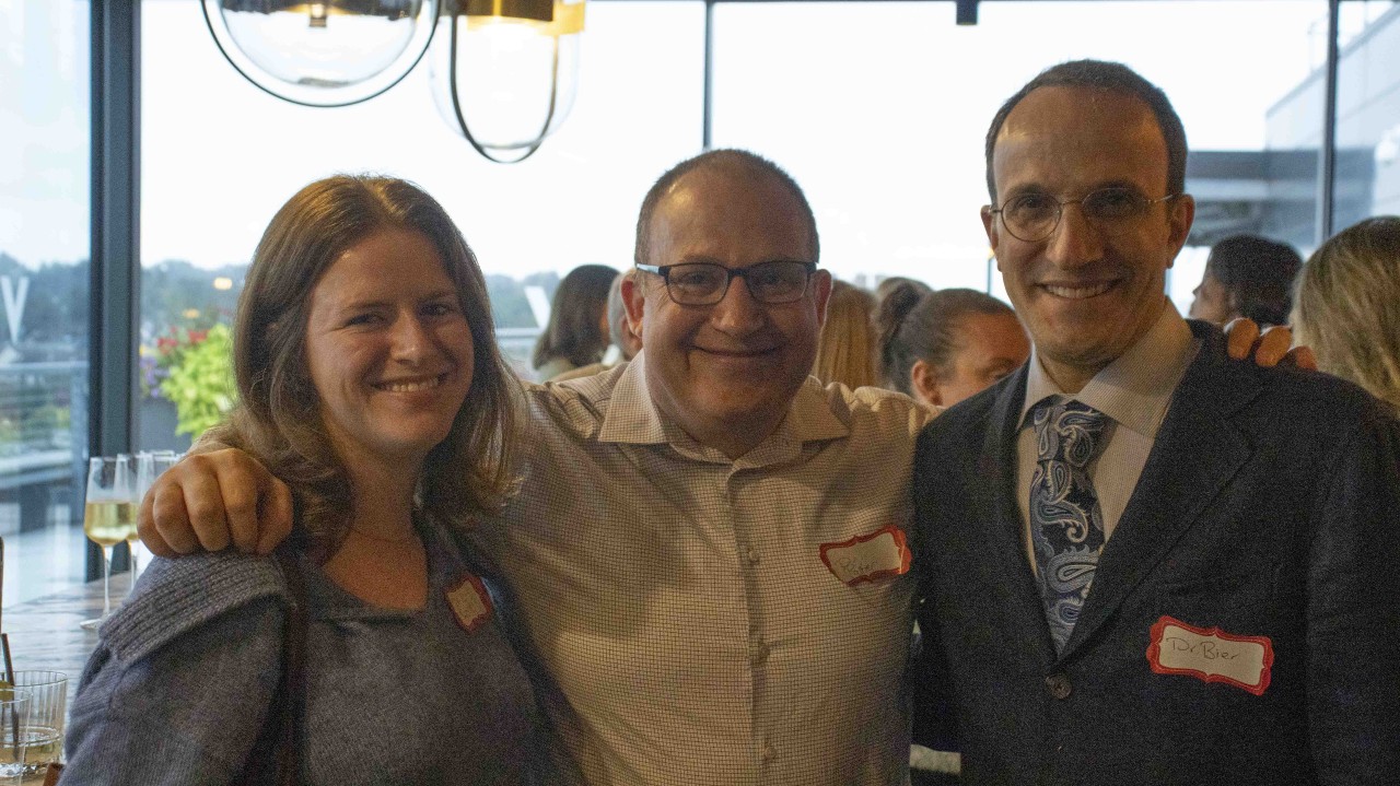 three people smiling